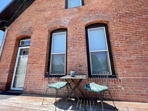 Deck off the living room with outdoor seating for two