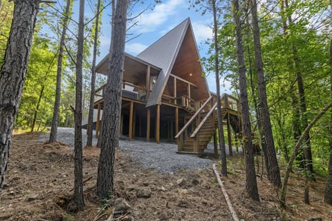 Charming A-Frame Retreat: Nestled in trees, enjoy serene views and modern outdoor living!