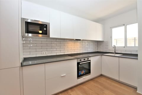 Another view of the bright open kitchen from another angle