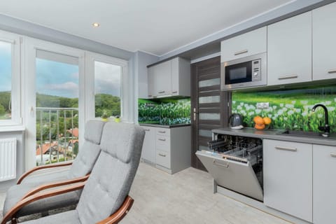 Kitchenette with plenty of kitchen utensils and dishes. 