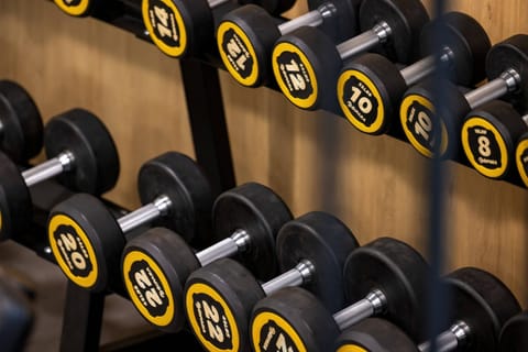 A close-up of gym weights, showcasing high-quality fitness amenities for residents.

