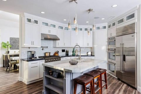 Imagine cooking in this fully remodeled Gourmet Chef's Delight Kitchen. Triple stack professional grade Thermador ovens, 6 burner stove, pot filler, and large island with extra large industrial style Farmhouse sink. Perfect for the family cook, and