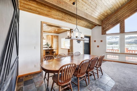 Open dining area with wood table and mountain-inspired design.