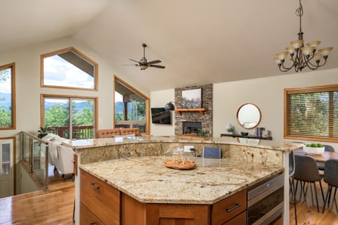 Kitchen opens up to living room/deck and dining area