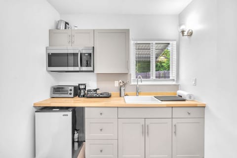 Mini kitchen with the basic essentials with sufficient space for your culinary needs.