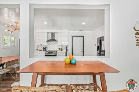 Stylish open-concept kitchen with modern dining and vibrant decor accents.