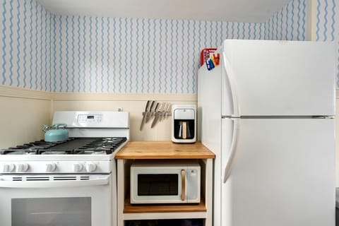 Gas range, microwave, coffee pot and fridge