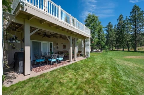 Beautiful patio and deck that face to a large lawn leading to the lake