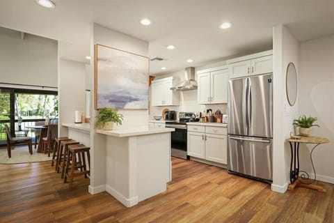 Full kitchen with breakfast bar and stainless steel appliances
