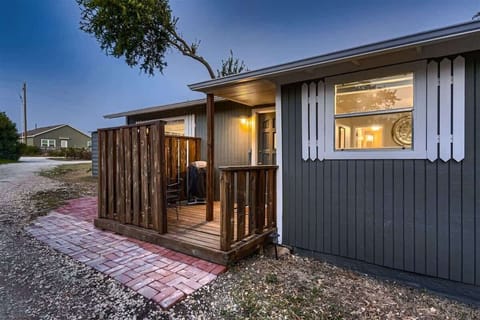 Arrive at a warm and inviting home, complete with a cozy front porch and softly lit entryway