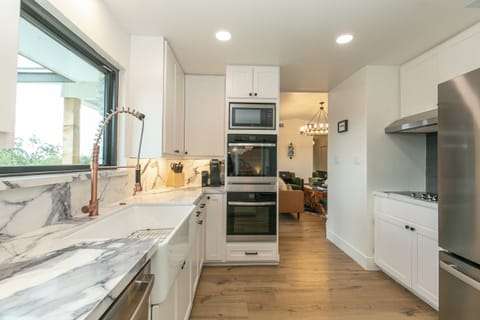 Gorgeous kitchen has Smart double ovens, electric cooktop, and picture window!