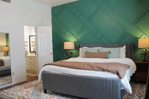 Enjoy the high ceiling, stylish accent wall, and king-size bed.