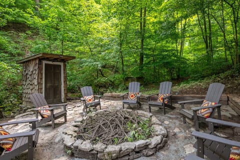 Behind the home is a beautiful firepit tucked into the hillside