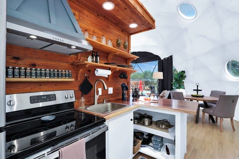 Kitchen is stocked with pans and utensils.