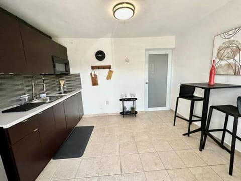 Galley kitchen with seating for two. 