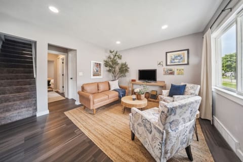 Comfortable living area with two chairs, sofa, and Smart TV