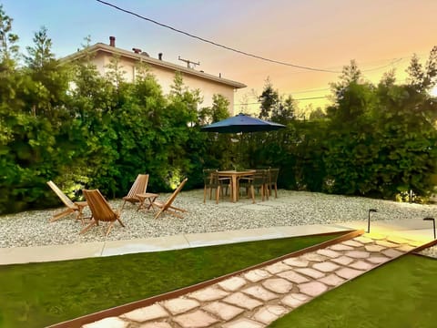 Gated large yard with hot tub, outdoor seating, propane grill, putting golf.