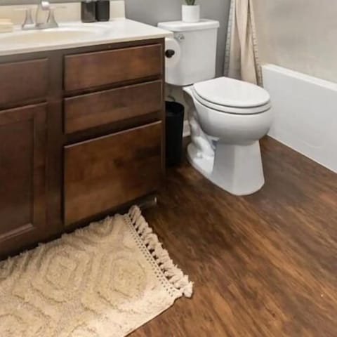 Bathtub, hair dryer, towels, toilet paper