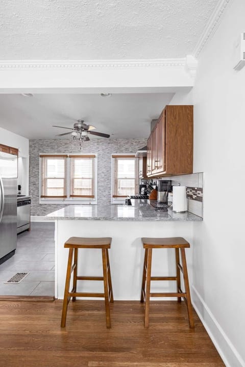 We've placed a few stools at the kitchen countertop, creating a casual and inviting space for you to enjoy while preparing meals or simply relaxing