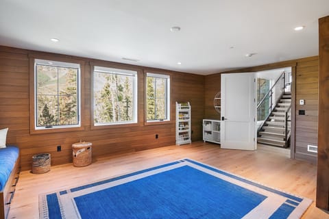 Ideally situated, the Bunk Room features a set of stairs leading to the main living area, as well as another set that descends to the downstairs media room and lower deck.