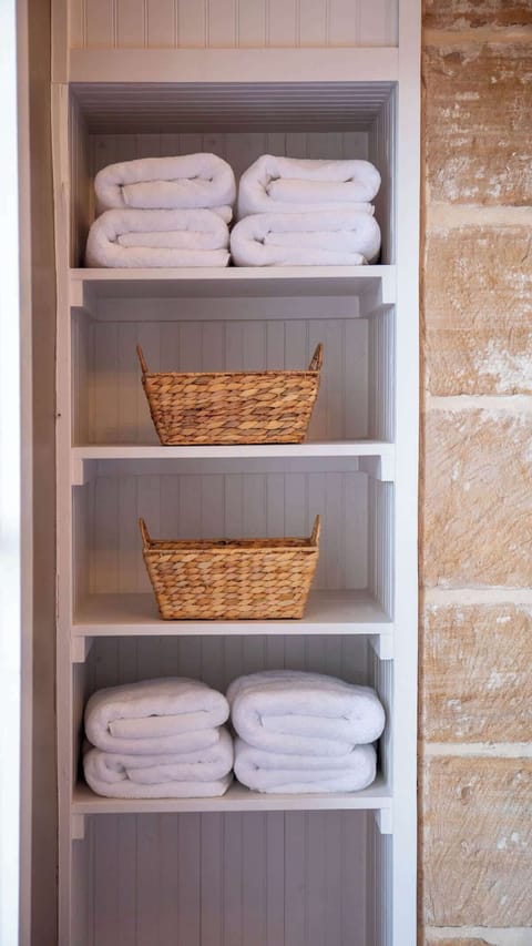 Fluffy soft towels and wicker baskets add a simple element of comfort.