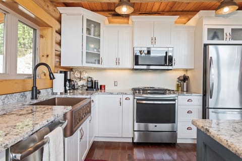 Stainless steel appliances with a beautiful copper farmhouse sink