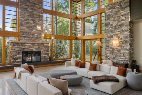 Gorgeous great room with 25 foot cherry ceilings, stone fireplace, and floor-to-ceiling windows.