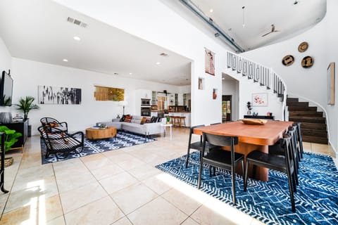 This captivating photo captures the seamless fusion of the dining area, living space, and sleek kitchen. An open-concept design that's both inviting and functional awaits your exploration.