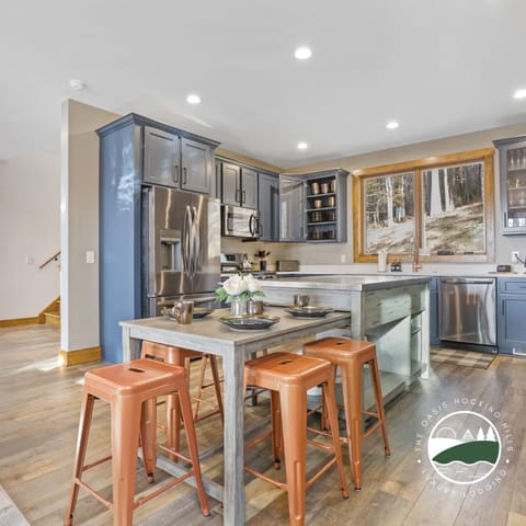 The central kitchen island also expands for additional seating.