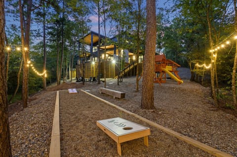 Outdoor Fun Zone: Delight in games and laughter under twinkling lights in nature's playground!