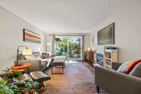 Bright living room with oversized sliding glass door and cozy fireplace