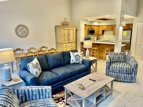 Family room seating area. Brand new furniture including couch and two swivel barrel chairs. 55” smart TV over the fireplace. Doors open up to upper level balcony with breathtaking views of Lake Lure and the surrounding mountains.