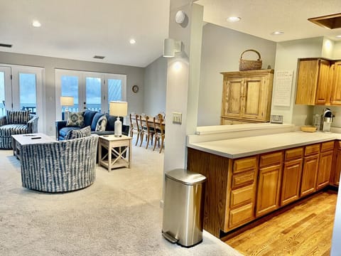 Photo of the open floor plan where the family room, dining table, and kitchen flow together.