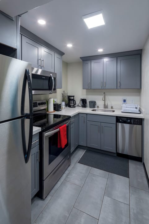 Kitchen with full-size fridge, electric oven and bar dishwasher
