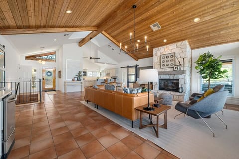 The main landing houses an open living room and kitchen along with access to the primary bedroom, grand living room, and expansive patio.