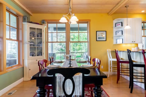 A sturdy wooden table, rich in texture and craftsmanship, sits as the centerpiece, surrounded by well-crafted chairs that showcase intricate details.