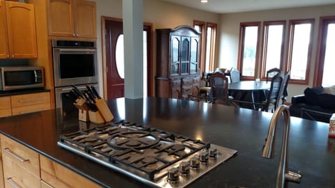 Featuring dual ovens, a 5-burner stovetop, and a pair of sinks for all your culinary needs.