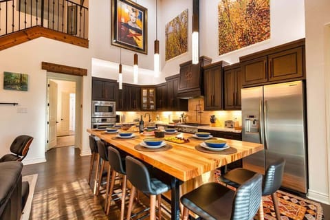 Custom pecan wood dining table with leather chairs for you to host all your meals during your stay. Fully stocked kitchen 