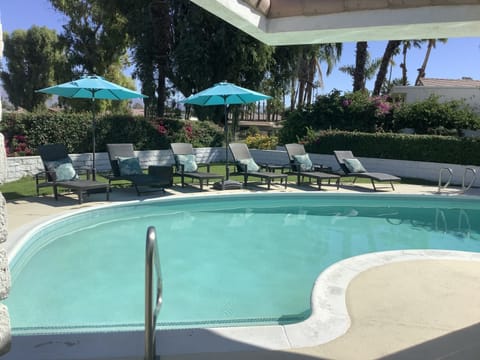 Backyard Oasis: six lounge chairs, side tables, umbrellas, views of golf course