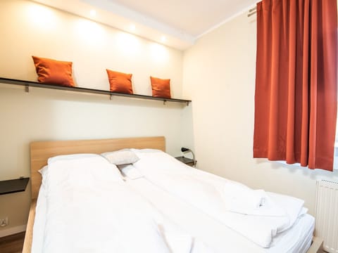 Cozy bedroom with a large bed – perfect for a romantic seaside stay.