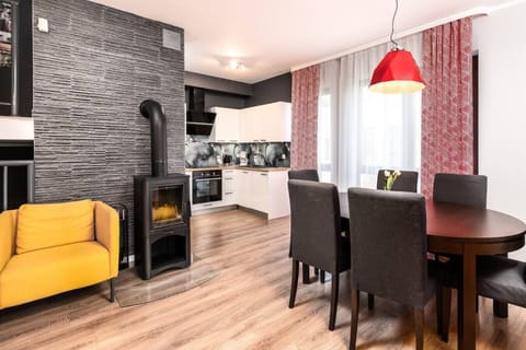 Cozy dining room with fireplace – a seaside luxury apartment full of charm.