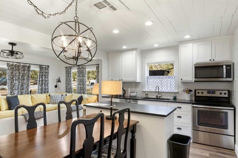 A big dining table is located conveniently next to the kitchen, and the open floor plan here allows everyone to be part of the conversation!