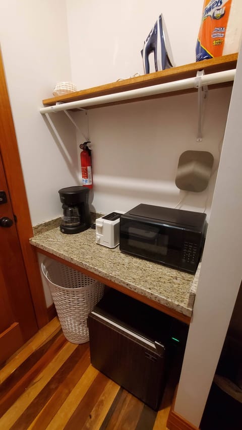 Kitchenette in master bedroom suite with microwave, mini-fridge, toaster, and coffee pot