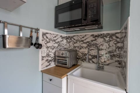 Small but efficient kitchenette w/ air fryer for easy meal prep.