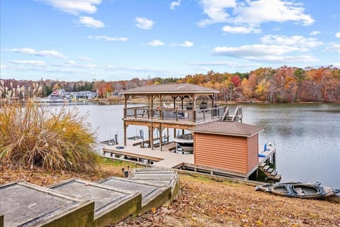 Impressive boat dock that features an amazing partially covered dock with a grill, smart TV, and lovely views of Lake Anna