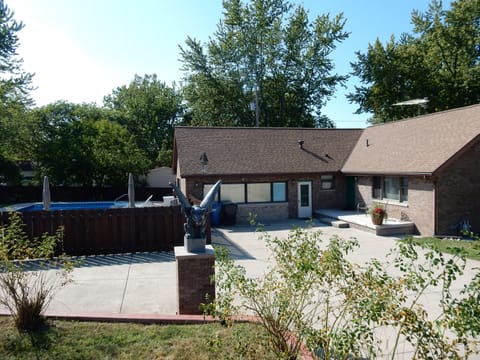 Front view of house, spacious cement driveway, two private front door entrances.