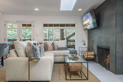 Cozy living area with comfortable sleeper sofa and wood burning fireplace
