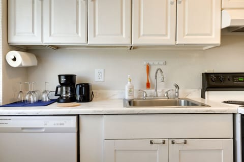 Fridge, stovetop, dishwasher, coffee/tea maker