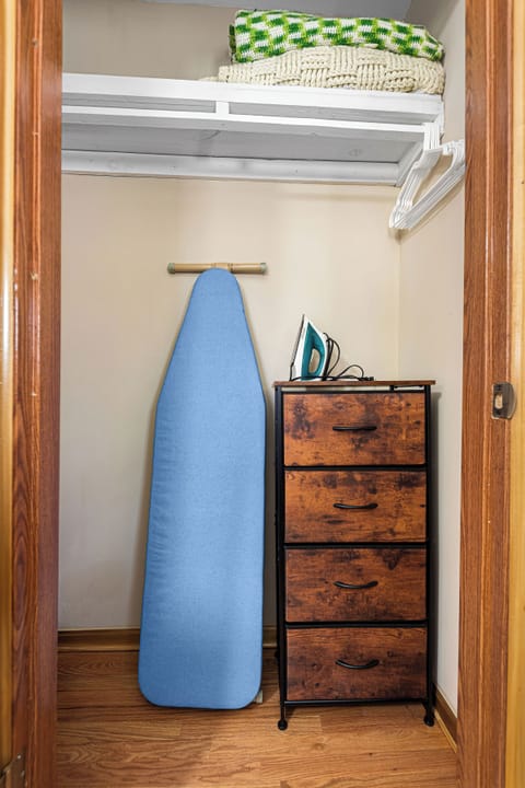 We store the baby high chair, iron, and ironing board in this room's closet.