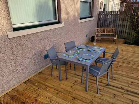 Outdoor dining overlooking back lawn